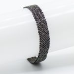 Bracciale trama preziosa fascetta argento placato rutegno nero e seta nera